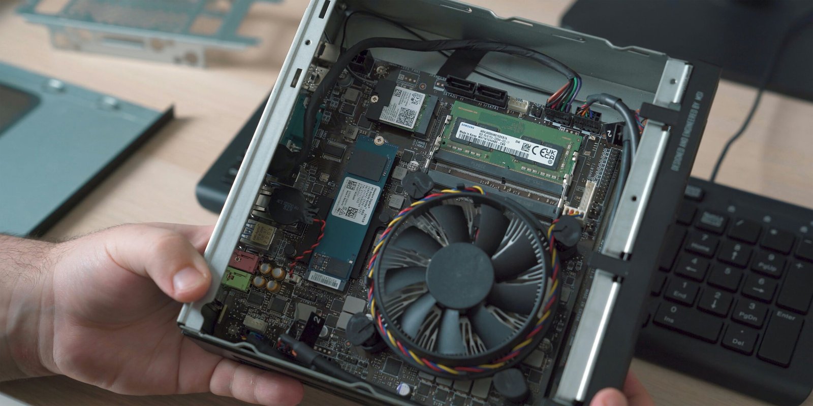 a person holding a laptop with a fan in their hand