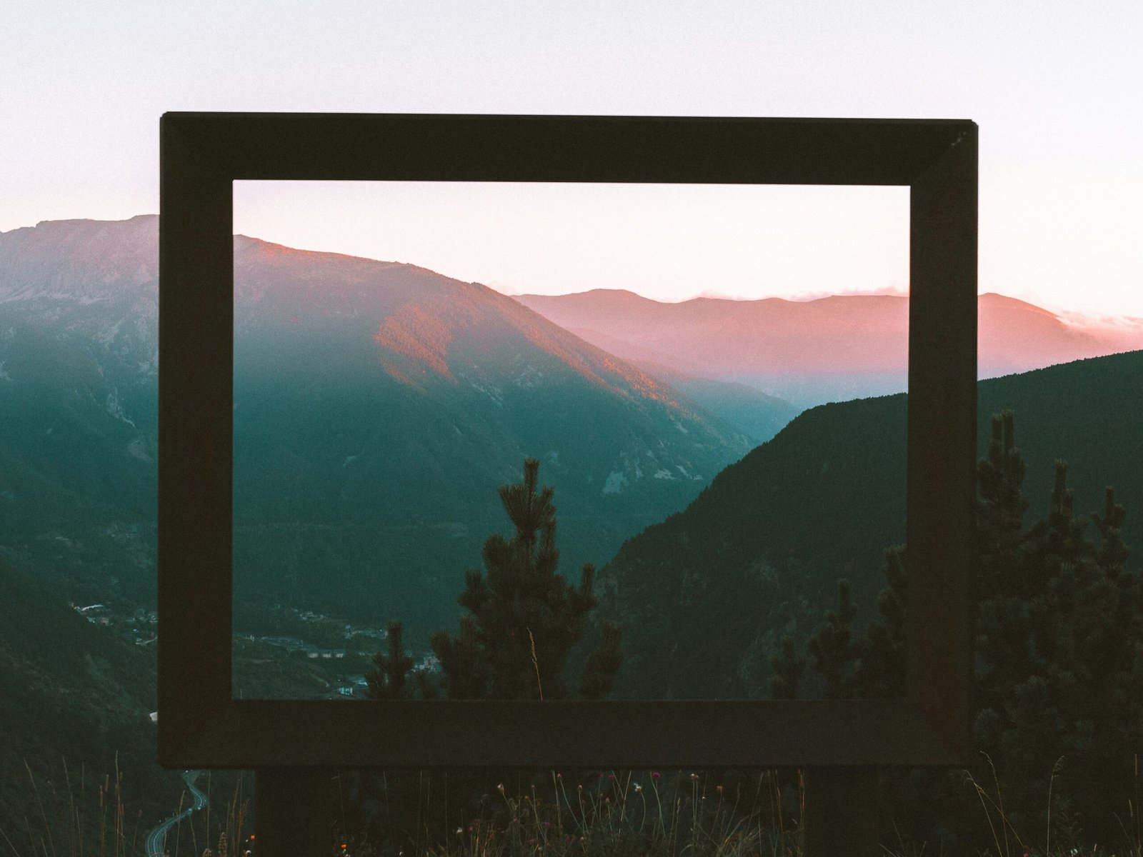 a picture frame sitting on top of a hill